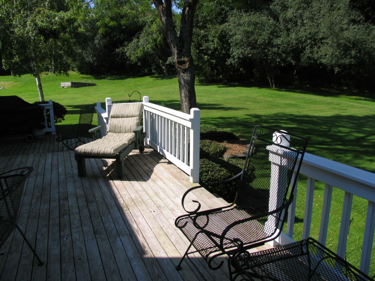 31 Old Barn Road Lenox, MA 01240 - Photo 40 of 56 a view of a patio with table and chairs potted plants and a palm tree