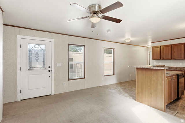 2875 North Hill Field Road, Unit 62 Layton, UT 84041 - Photo 10 of 34 Entry area with a decorative glass front door, two windows, and a ceiling fan