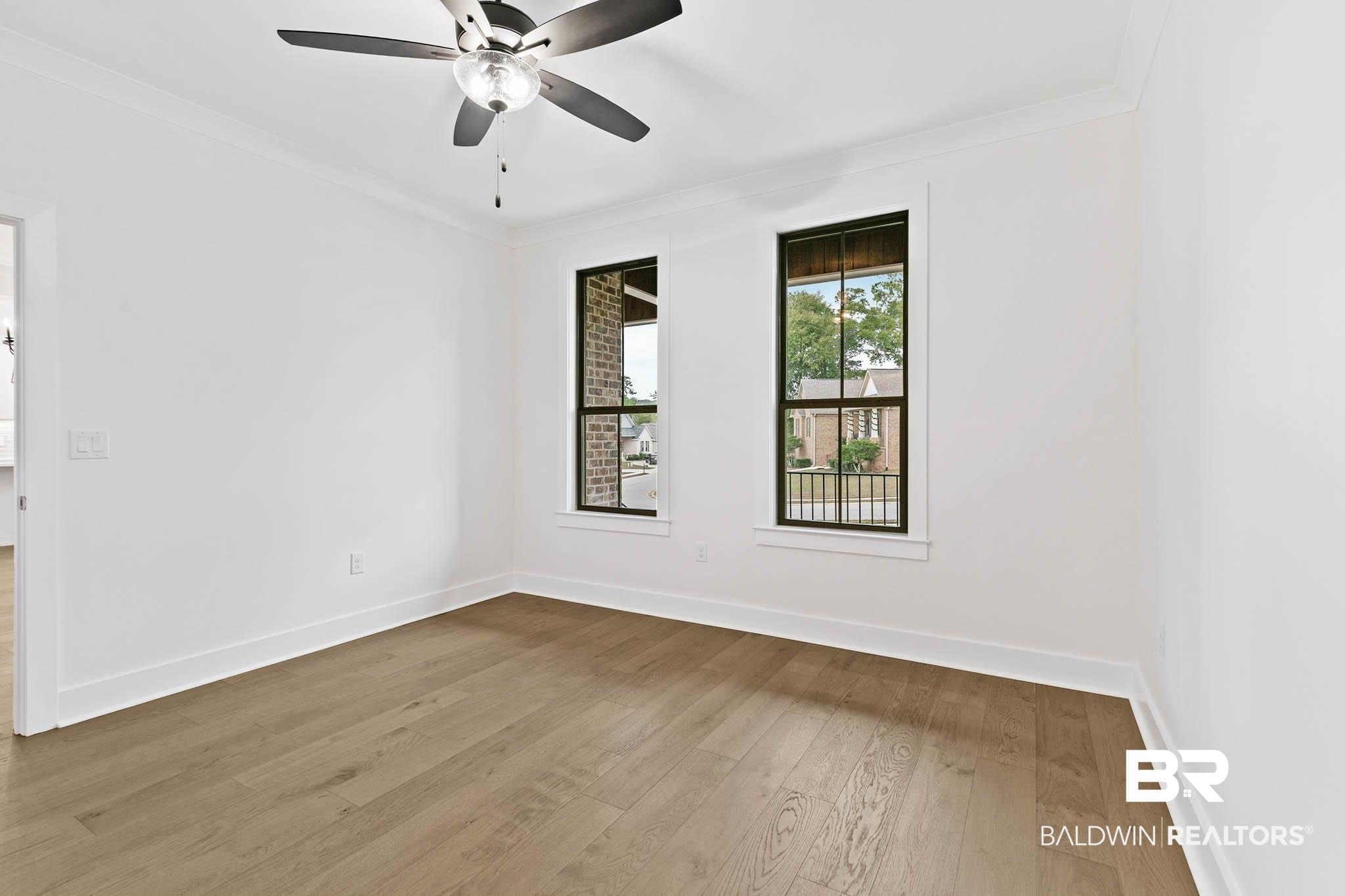 6656 Garrison Drive Daphne, AL 36527 - Photo 9 of 57 Unfurnished room with crown molding, wood-type flooring, and a ceiling fan