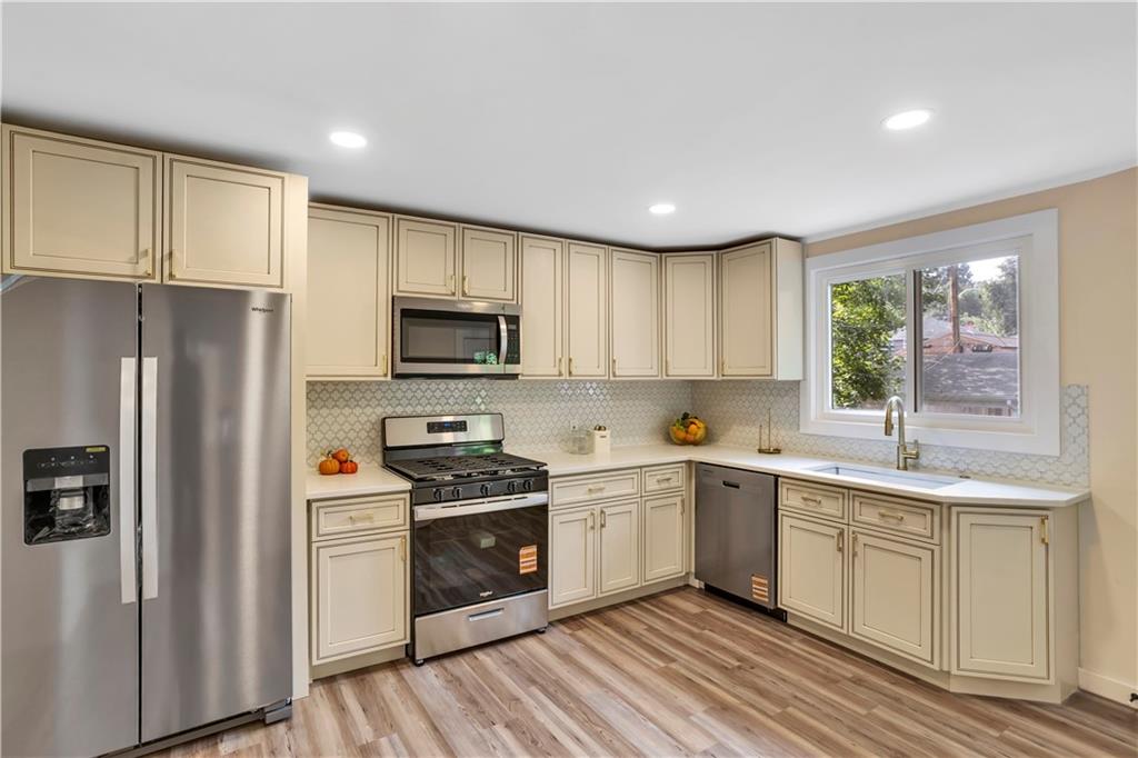 1430 Ridge Avenue Coraopolis, PA 15108 - Photo 14 of 32 a kitchen with a sink a window and stainless steel appliances