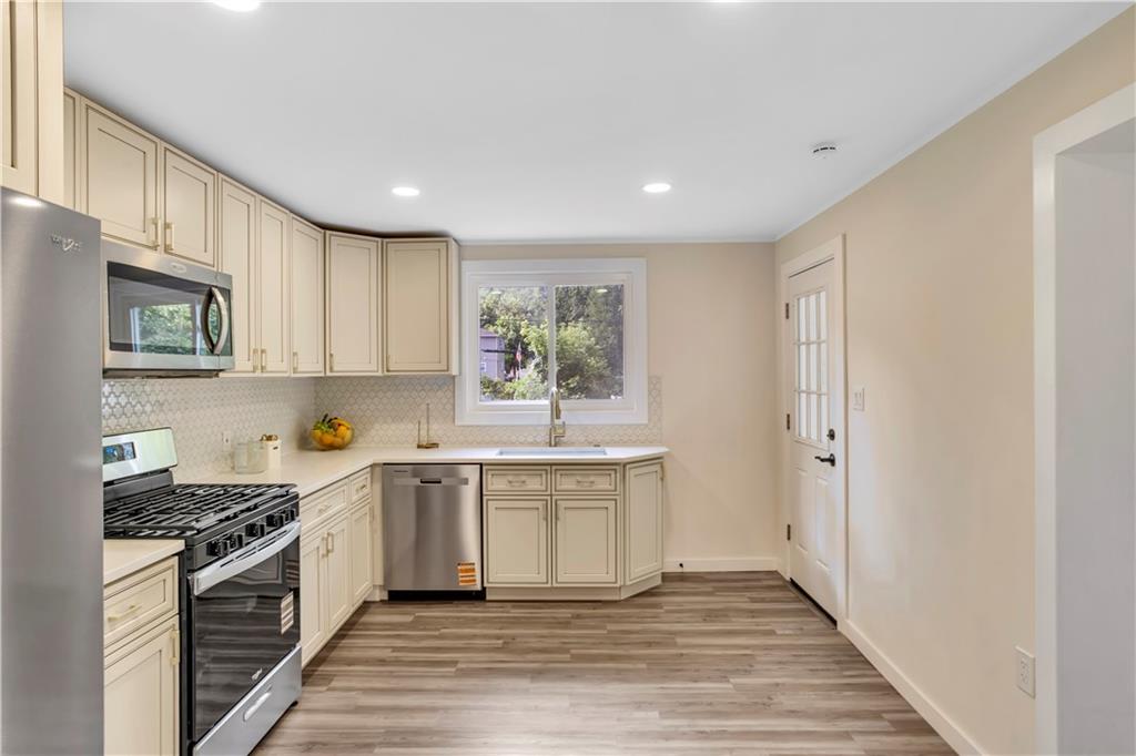 1430 Ridge Avenue Coraopolis, PA 15108 - Photo 15 of 32 a kitchen with stainless steel appliances granite countertop a stove a sink and a refrigerator