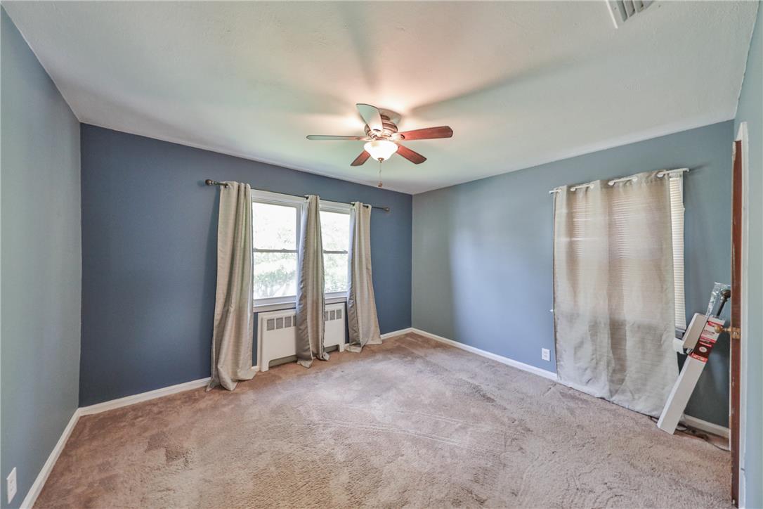 3050 Cornwall Road Bethlehem, PA 18017 - Photo 30 of 80 Well-lit room with ample natural light, featuring a ceiling fan and wall heating units.