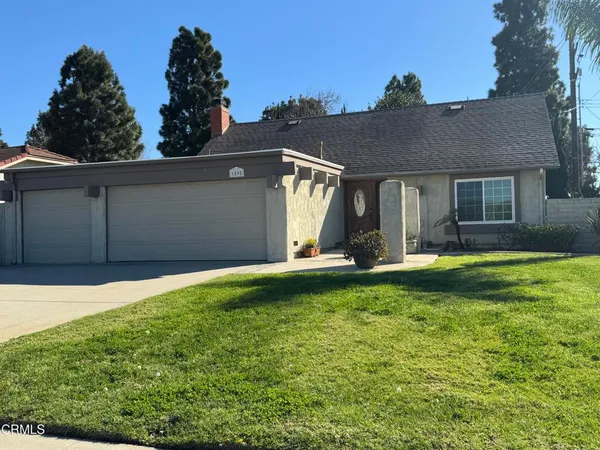 a view of a house with pool and a yard