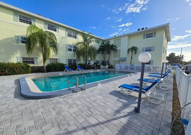 a patio with a table and chairs