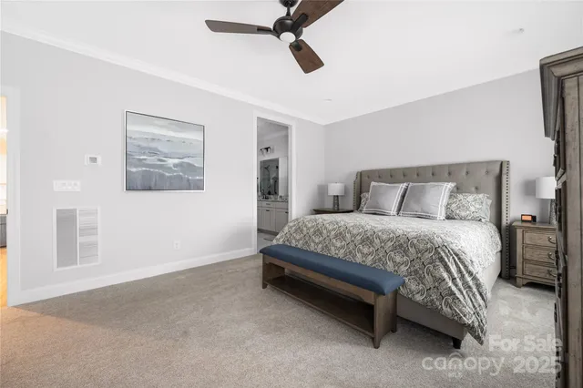 a bedroom with a bed and painting on the wall