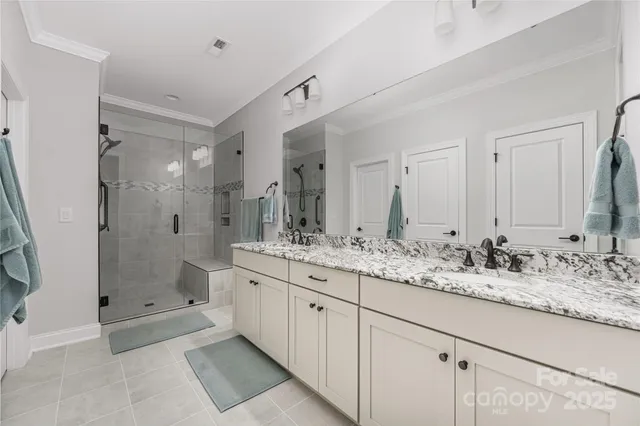 a bathroom with a shower sink and mirror