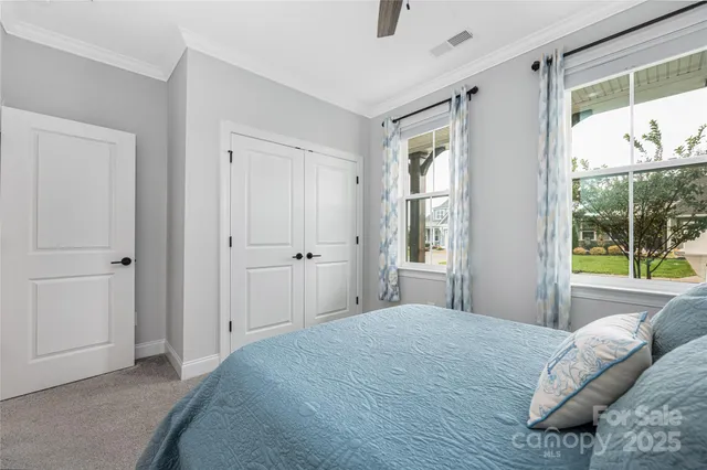 a bedroom with a bed and a large window