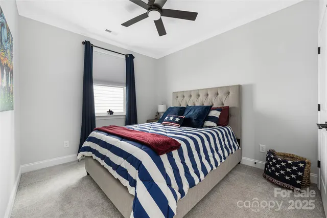 a bed sitting in a bedroom next to a window