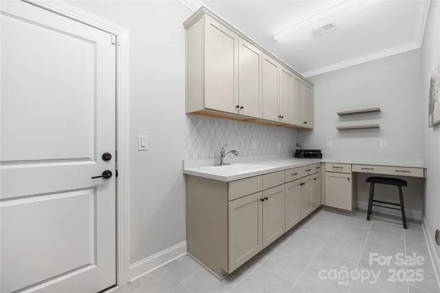 a kitchen with sink cabinets and white appliances