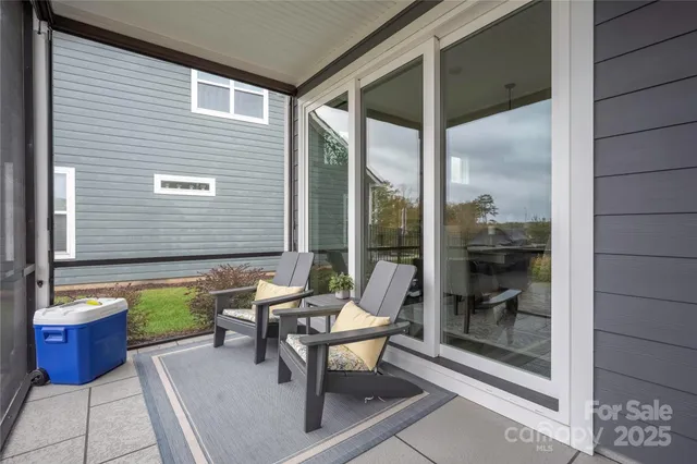 a balcony with furniture and next to a window