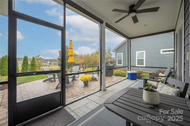 a living room with a floor to ceiling window and potted plants