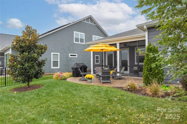 a view of a house with backyard sitting area and garden