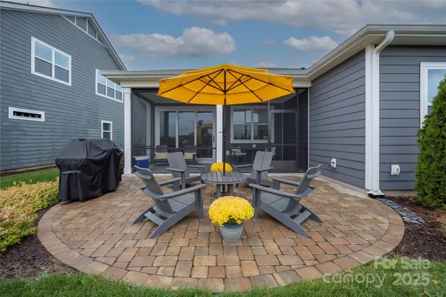 a view of a house with backyard and sitting area