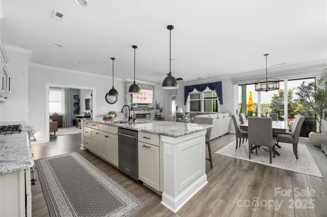 a kitchen with stainless steel appliances granite countertop a stove and white cabinets