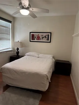 a bedroom with a bed and cabinets