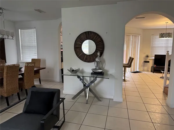 a view of a workspace with furniture and a mirror