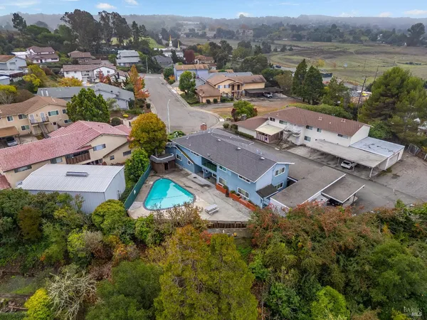 a view of a house with swimming pool and sitting area