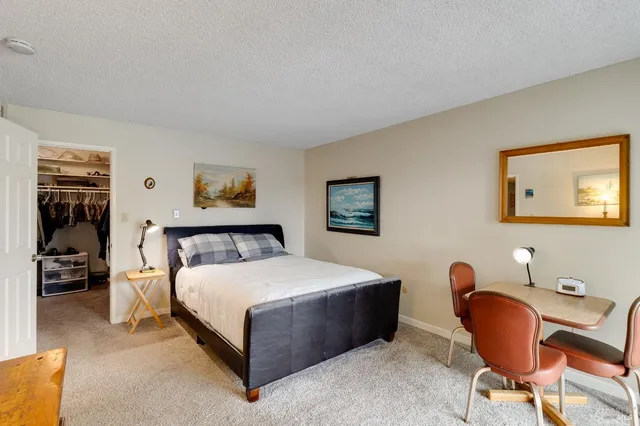 a living room with furniture a table and a large window