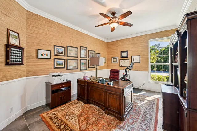 a living room with furniture and a floor to ceiling window