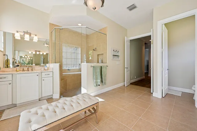 a bathroom with a sink shower and a mirror