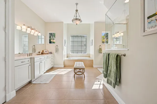 a large white kitchen with cabinets and wooden floor