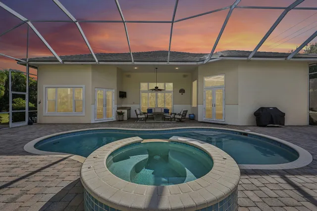 a swimming pool with outdoor seating