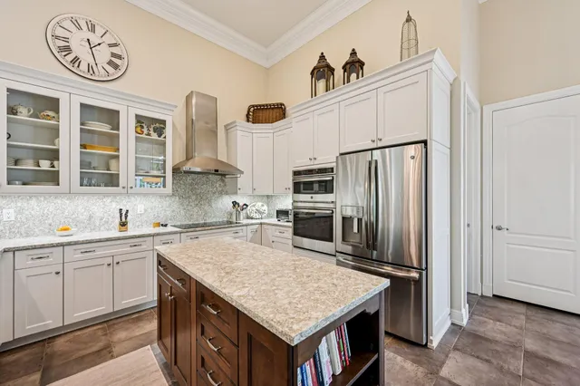a kitchen with cabinets and stainless steel appliances