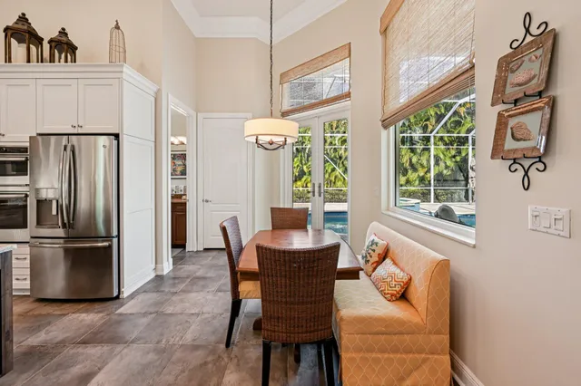 a kitchen with stainless steel appliances granite countertop a refrigerator and a table
