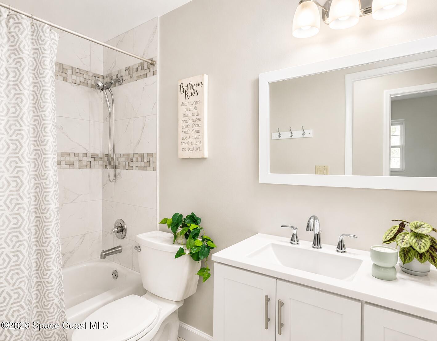 987 Kings Post Road Rockledge, FL 32955 - Photo 21 of 30 a bathroom with a sink toilet and shower