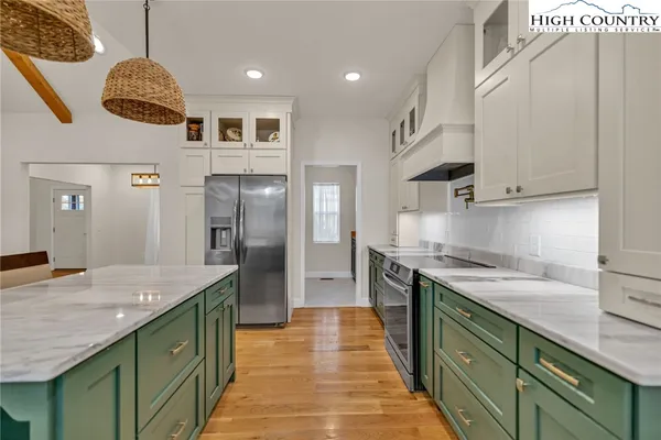 a kitchen with stainless steel appliances granite countertop a sink and cabinets