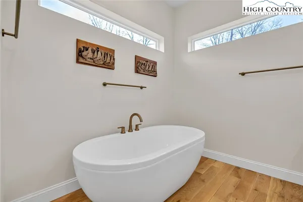 a white bath tub sitting next to a white sink