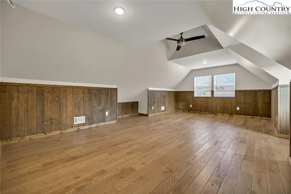 a view of a livingroom with a fireplace and wooden floor