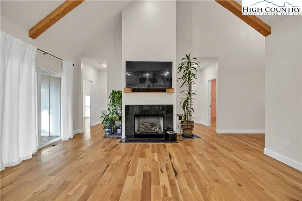 a living room with a fireplace and a flat screen tv