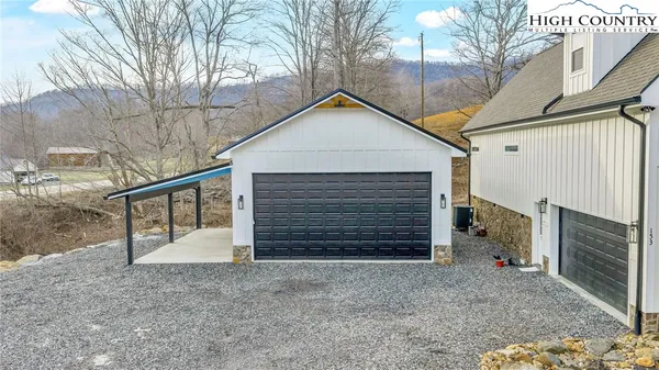 a view of a house with a yard and garage