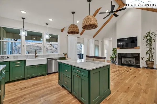 a kitchen with kitchen island a sink counter top space and appliances