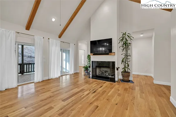 a view of a livingroom with a fireplace a fireplace and wooden floor