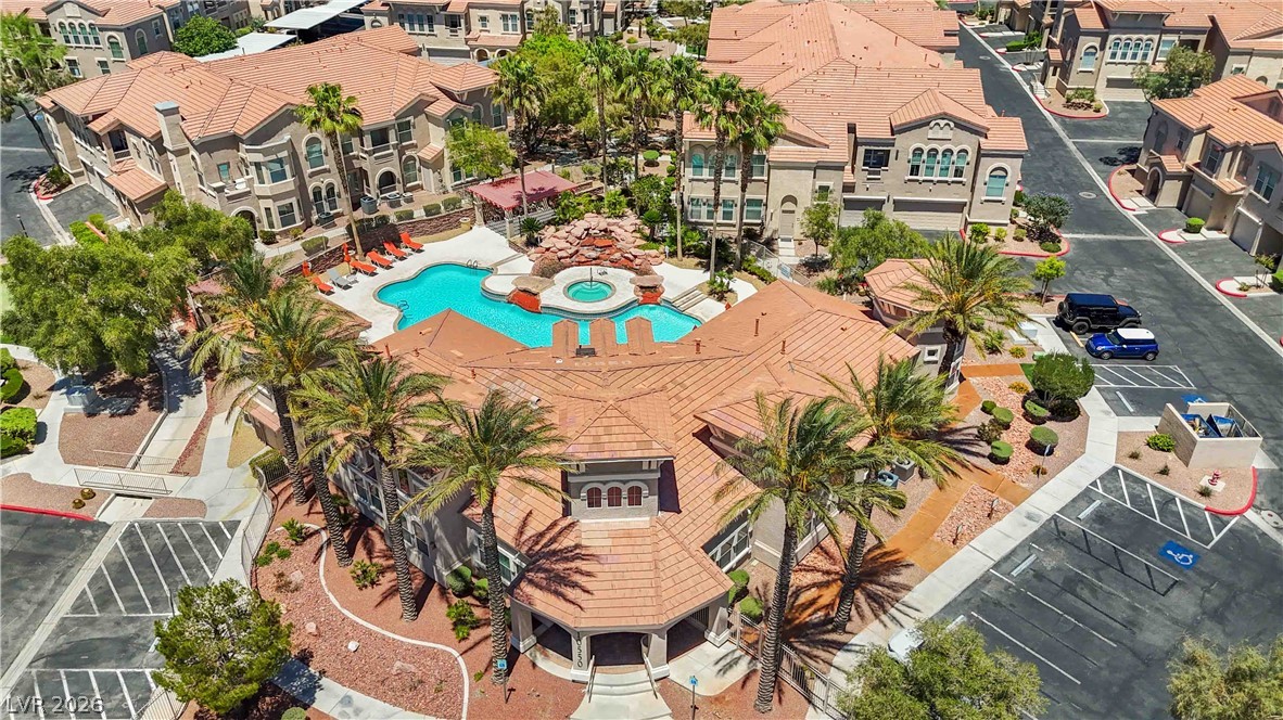 10550 West Alexander Road, Unit 2060 Las Vegas, NV 89129 - Photo 35 of 45 Discover a vibrant community offering resort-style amenities, complete with a sparkling pool and spa, surrounded by lush landscaping.