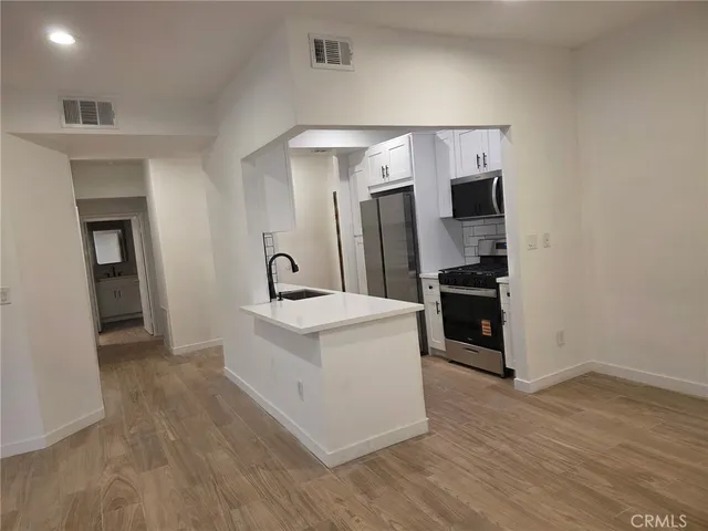 a view of kitchen with stainless steel appliances a refrigerator and a stove