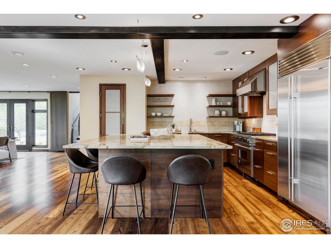 3750 Spring Valley Road Boulder, CO 80304 - Photo 11 of 39 a kitchen with granite countertop a table chairs stove and cabinets