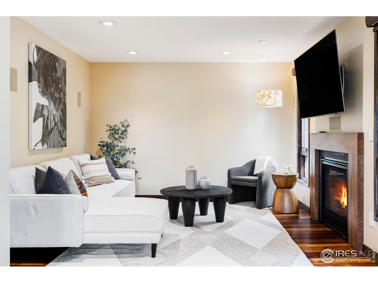 3750 Spring Valley Road Boulder, CO 80304 - Photo 15 of 39 a living room with furniture a flat screen tv and a fireplace