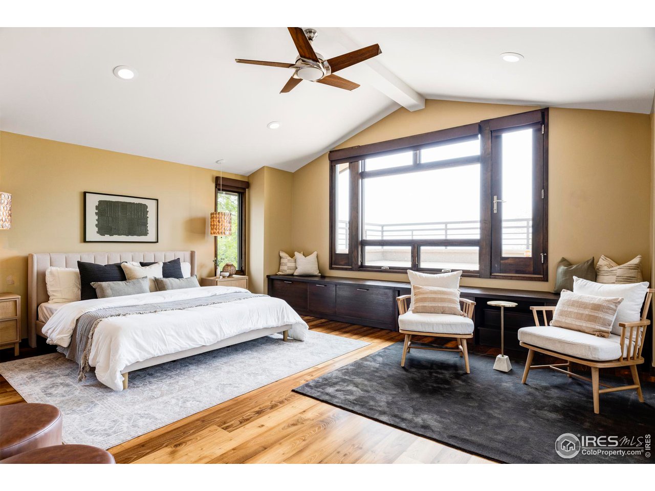 3750 Spring Valley Road Boulder, CO 80304 - Photo 19 of 39 a spacious bedroom with a bed a couch and a window