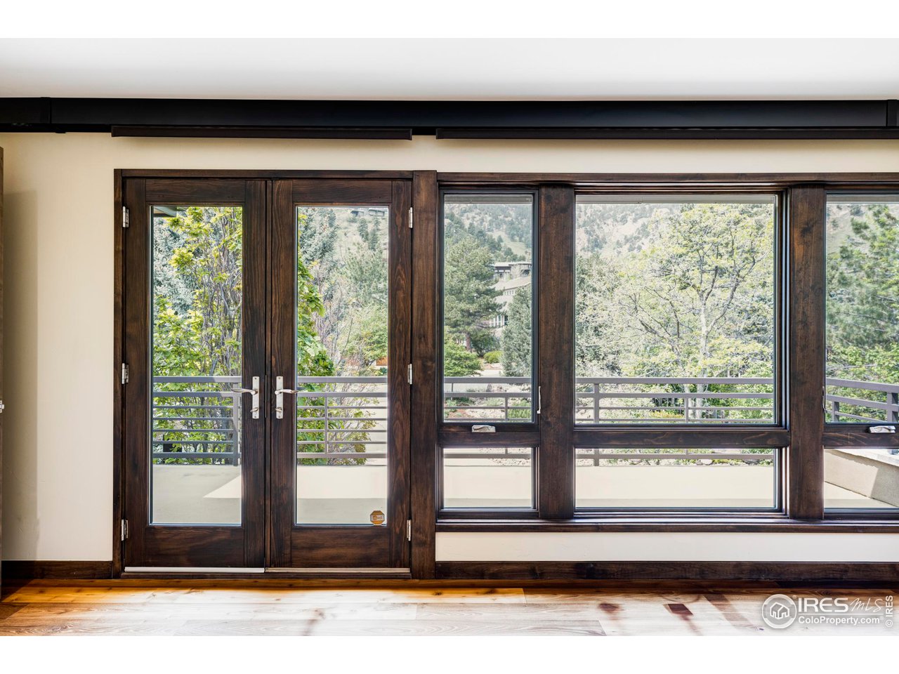 3750 Spring Valley Road Boulder, CO 80304 - Photo 24 of 39 a view of backyard with a large window and wooden floor