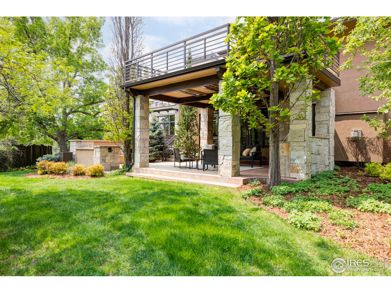 3750 Spring Valley Road Boulder, CO 80304 - Photo 36 of 39 a view of a chair and table in backyard of the house