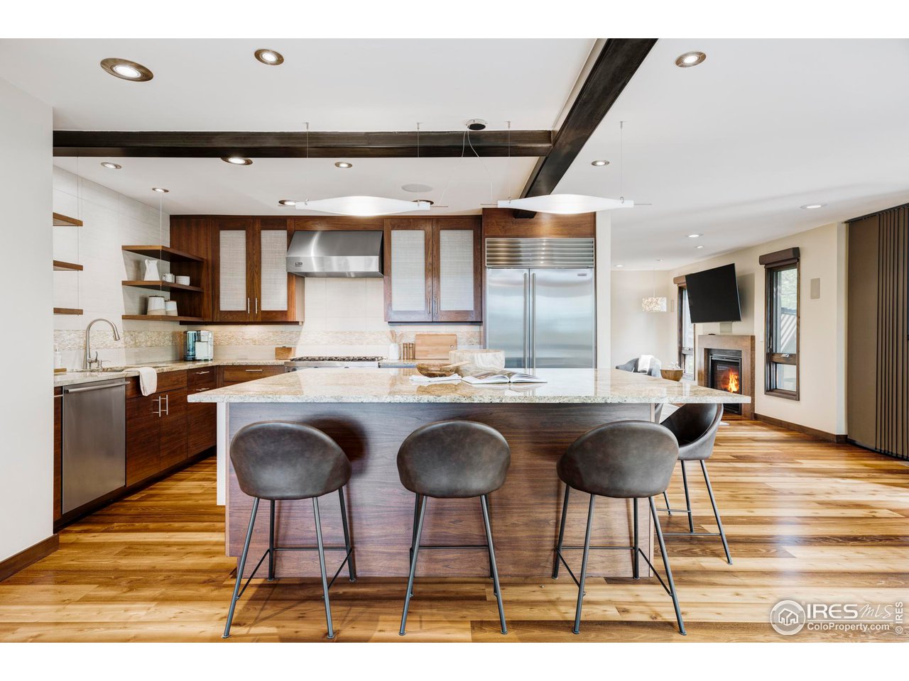 3750 Spring Valley Road Boulder, CO 80304 - Photo 10 of 39 a kitchen with granite countertop a table chairs stove and cabinets