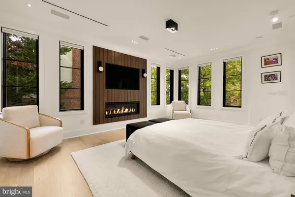 a bedroom with a bed table and chair