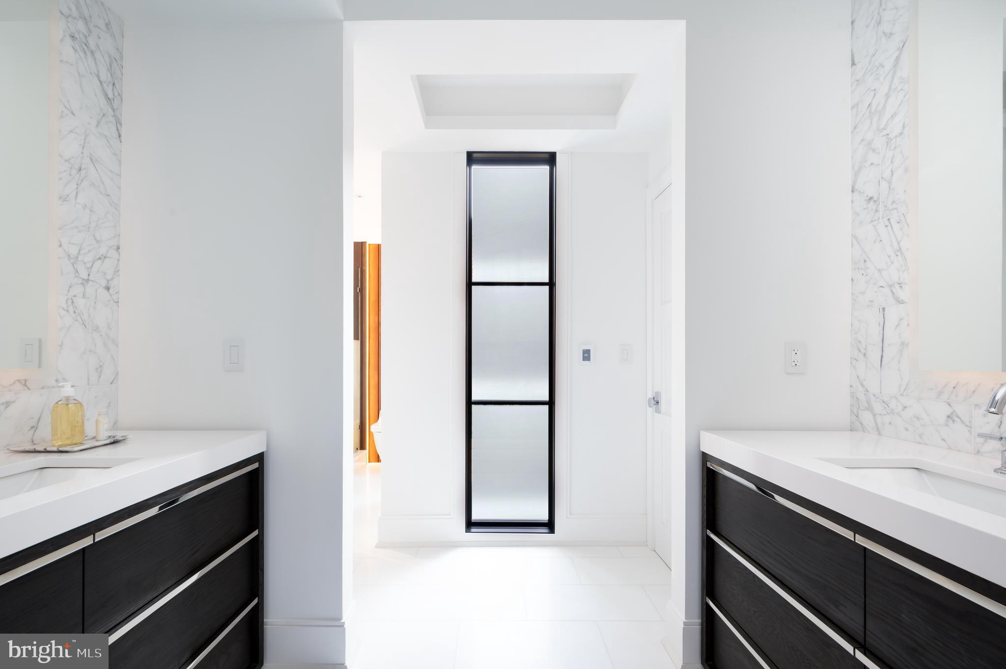 3302 Cleveland Avenue Northwest Washington, DC 20008 - Photo 24 of 54 Primary Windowed 5 fixture marble bathroom