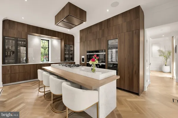 a living room with stainless steel appliances furniture stove and flat screen tv