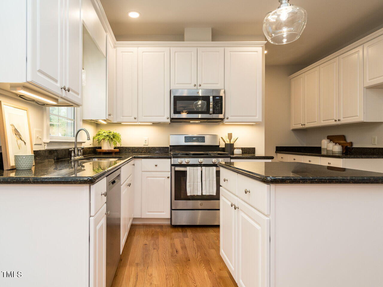 760 Hadrian Drive Garner, NC 27529 - Photo 13 of 38 a kitchen with granite countertop a sink and cabinets