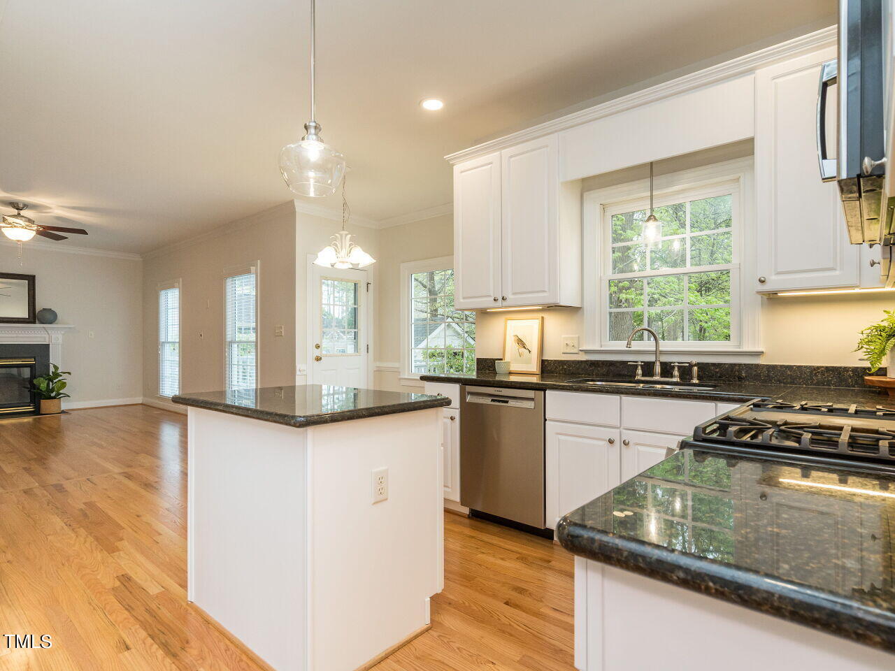 760 Hadrian Drive Garner, NC 27529 - Photo 15 of 38 a kitchen with granite countertop a stove a sink a counter space and cabinets