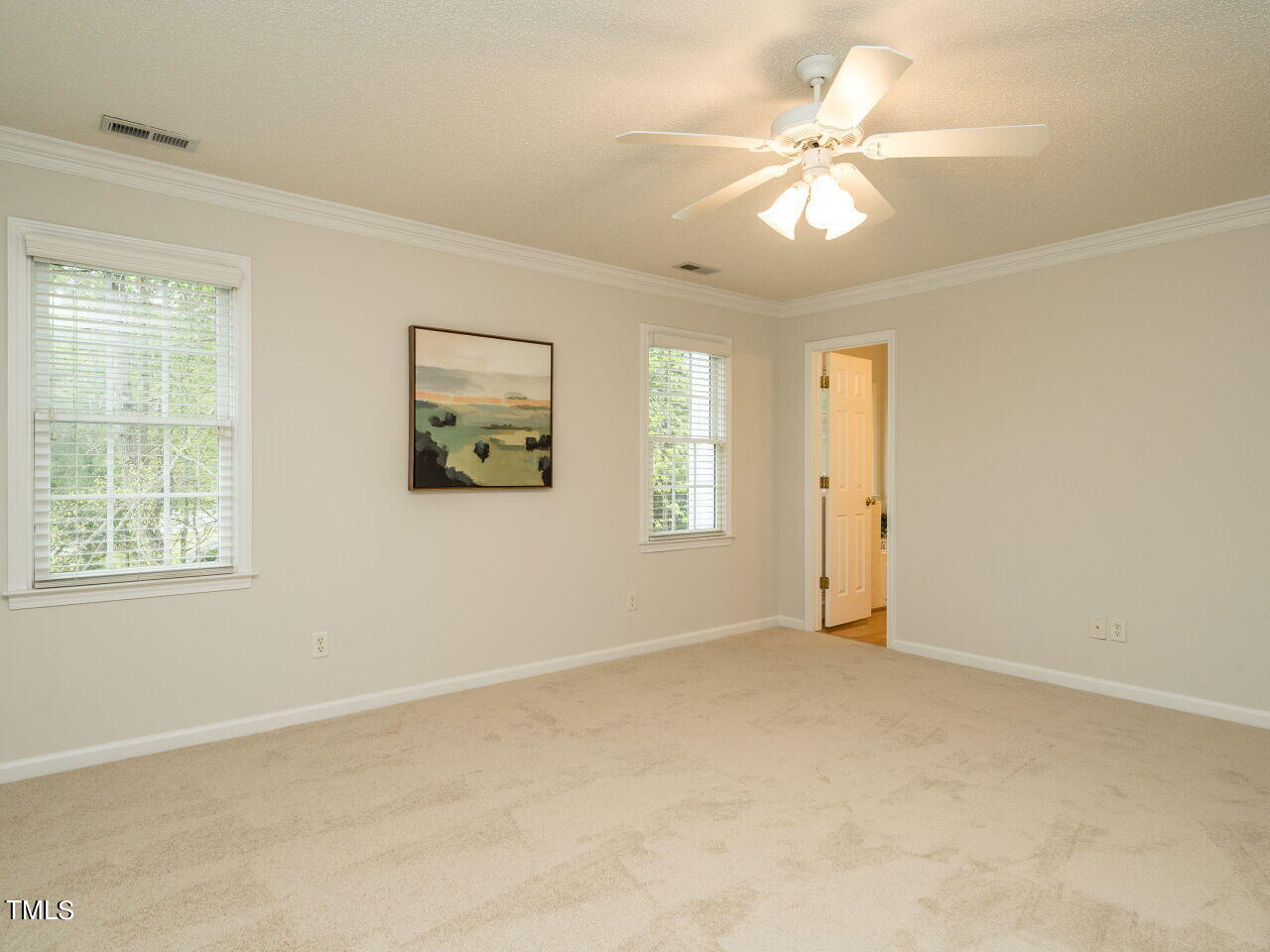 760 Hadrian Drive Garner, NC 27529 - Photo 21 of 38 an empty room with windows and fan